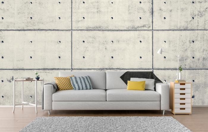 Vlies-Fototapete Betonwand mit Löchern in einem Farbton in Creme