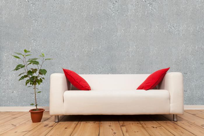 Vlies-Fototapete hellgraue Betonwand in einem Wohnzimmer